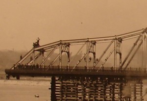 1906 photo of workers hanging on University Heights bridge as it was being moved to 207th Street in Inwood, New York. 