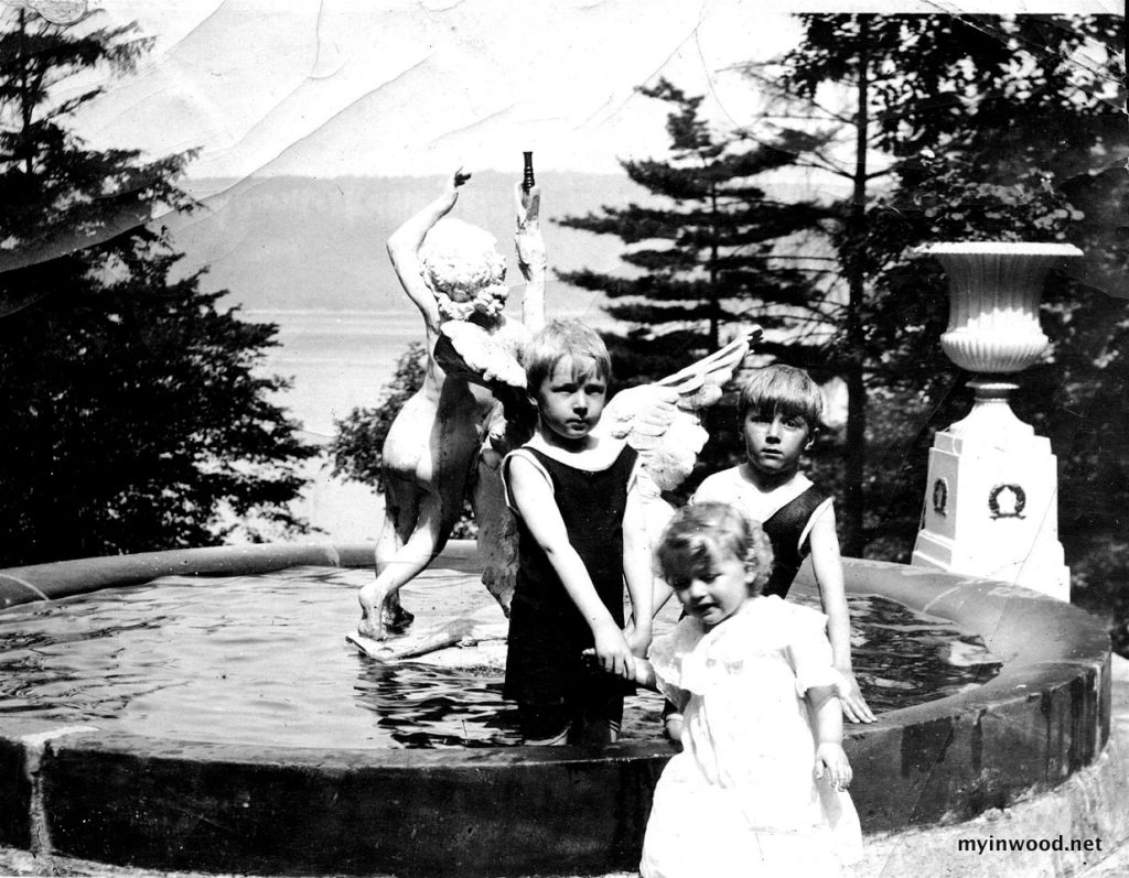 Walter (left), Otway (right), and Ursula Burns play in a fountain on Inwood Hill overlooking the Hudson River on the grounds of Ursulian Terrace, the family home.  (Photo courtesy: Peter Landry) 