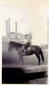 Photo from Nancy Clark Townsend, Bub on Barney – one of several horses and ponies at the Speedway Riding Ring – 3 times around for 25 cents. (Sherman Creek Power Generation Station in background)