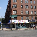 4971 Broadway in 2014. The old pharmacy sign is hidden beneath this frozen yogurt sign.