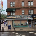 Broadway and Isham Street, Isham Park Pharmacy sign exposed during 2013 renovation. Now a frozen yogurt shop