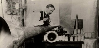 Lionel Mapleson with Edison Home Phonograph and extra large horn, probably at the Metropolitan Opera House, circa 1901-1903, Source NYPL.