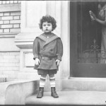 Little boy in sailor suit on front stoop of Vermilyea Avenue apartment building, ca. 1913, photo by William Hassler, NYHS