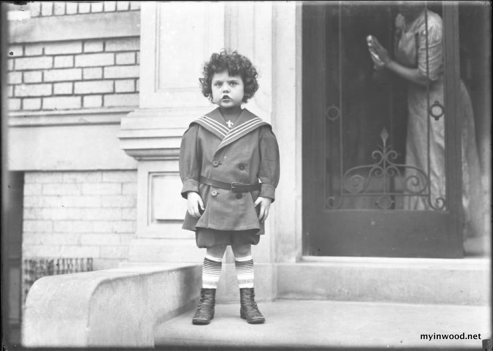 Little boy in sailor suit on front stoop of Vermilyea Avenue apartment building, ca. 1913, photo by William Hassler, NYHS
