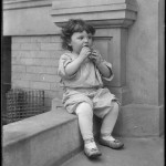 Toddler on front stoop of Vermilyea Avenue apartment building, undated