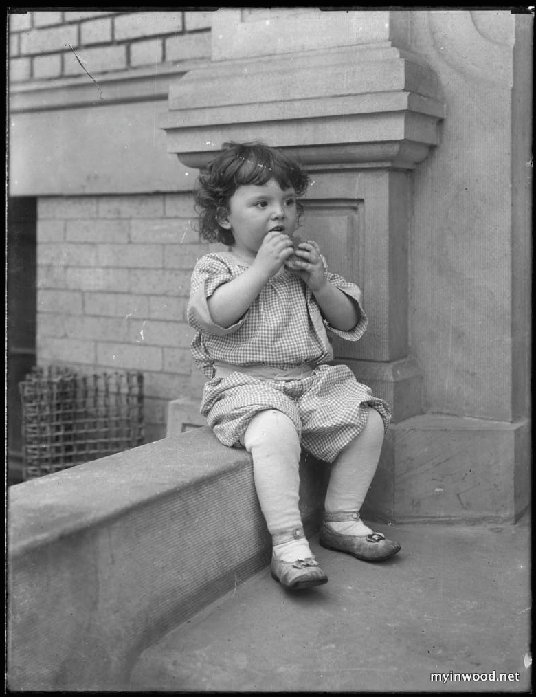 Toddler on front stoop of Vermilyea Avenue apartment building, photo by William Hassler, undated, NYHS.