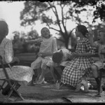 William Gray Hassler and four unidentified girls, seated on park benches, talking, Isham Park, Inwood, New York City, ca. 1913-1914, William Hassler, NYHS