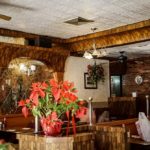 Poinsettias add a touch of class in this April 2019 photograph of the Capitol Restaurant, Broadway and West 207th Street, Inwood, NYC.