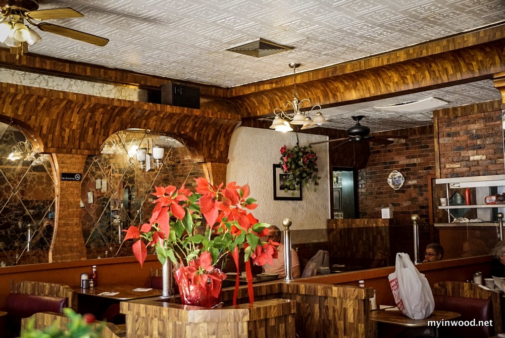 Poinsettias add a touch of class in this April 2019 photograph of the Capitol Restaurant, Broadway and West 207th Street, Inwood, NYC. 