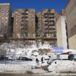5051 Broadway, currently home is a pay parking lot, is being offered up in a Government auction.